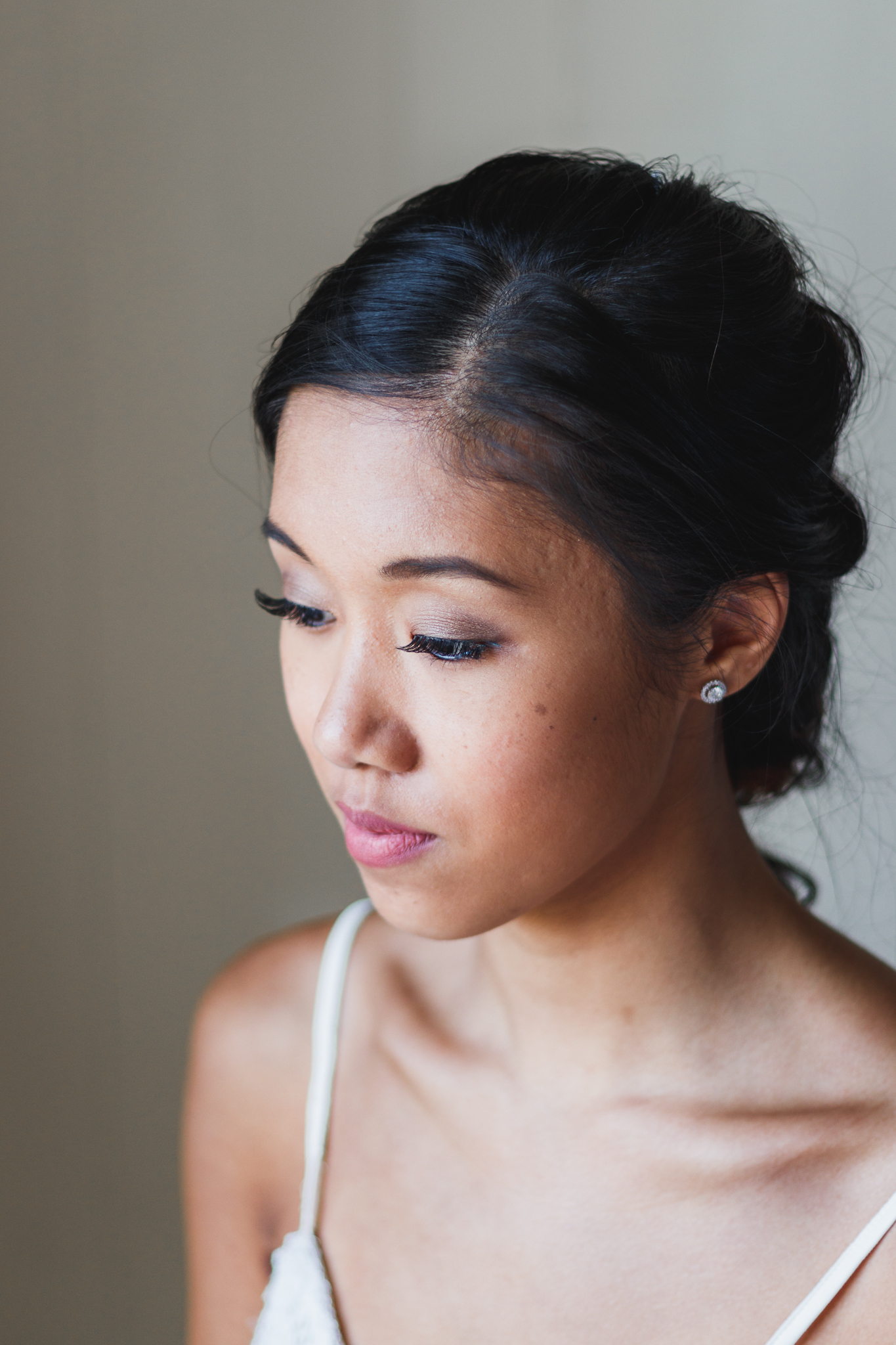 bride with makeup applied for her wedding in a soft natural style.