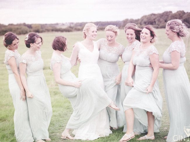 Bride and bridesmaid enjoying a countryside setting for photos.