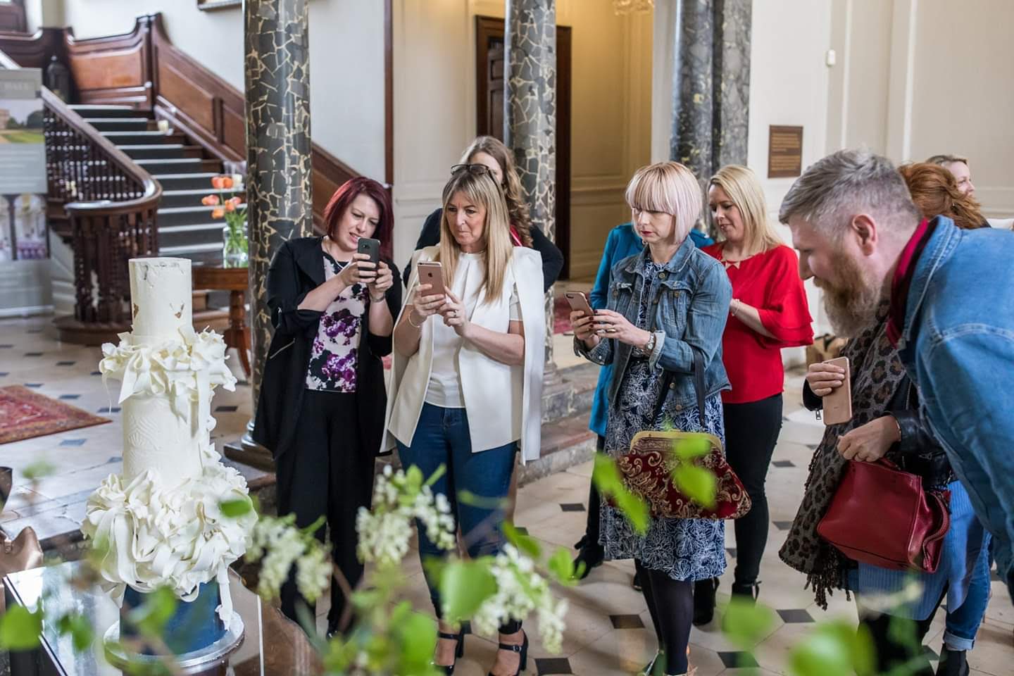 wedding experts viewing a royal cake made on extreme cake makers.