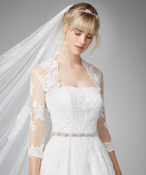 a women wearing a wedding gown with styled hair and makeup